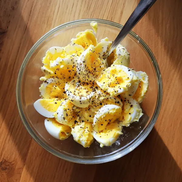 5 Healthy High-Protein Bagel Toppings That Actually Keep You Full 26 chopped hard-boiled eggs with black pepper in a glass bowl – bagel toppings prep