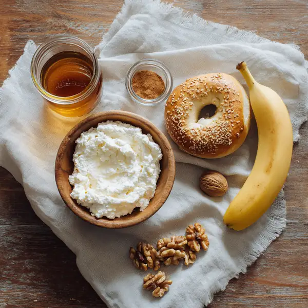 5 Healthy High-Protein Bagel Toppings That Actually Keep You Full 20 flat lay of bagel toppings ingredients including ricotta, banana, honey, cinnamon, and walnuts