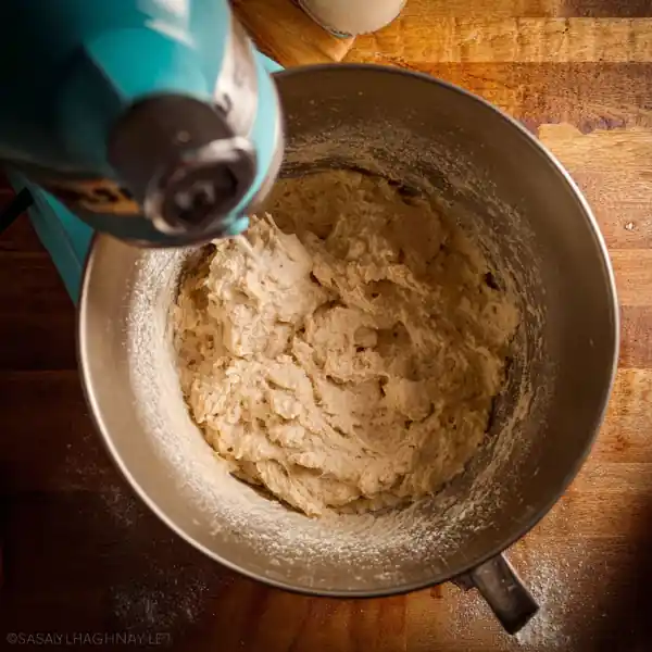 Everything Bagel You’ll Love, Easy, Homemade & High Protein 14 thick everything bagel dough mixing in stand mixer bowl with flour on wooden counter