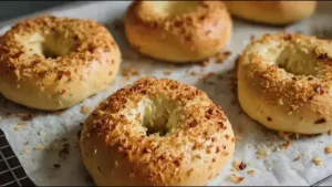 golden brown onion bagels topped with crispy caramelized onions on parchment