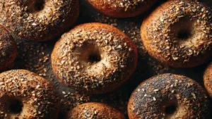 Multigrain bagels fresh from oven on a rustic rack