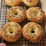 These Protein Bagels With Almond Flour Are So Good, Even the Kids Ate Them 11 freshly baked Protein Bagels with Almond Flour That Actually Taste Good (Yep, Even the Kids Ate Them), with everything seasoning on parchment paper