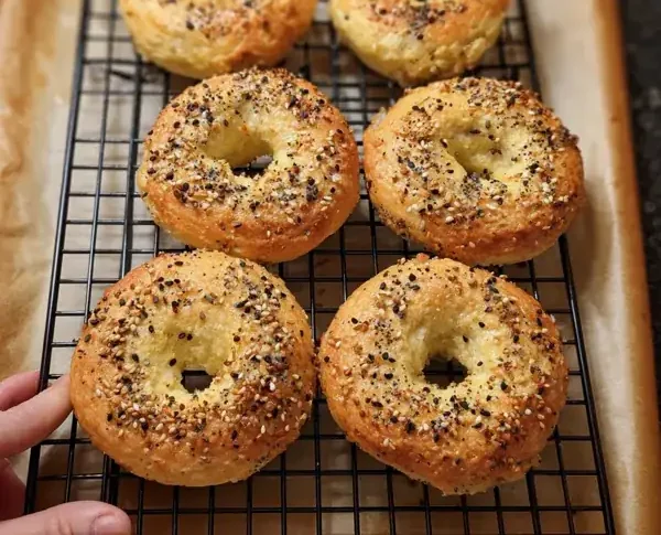 These Protein Bagels With Almond Flour Are So Good, Even the Kids Ate Them 16 freshly baked Protein Bagels with Almond Flour That Actually Taste Good (Yep, Even the Kids Ate Them), with everything seasoning on parchment paper