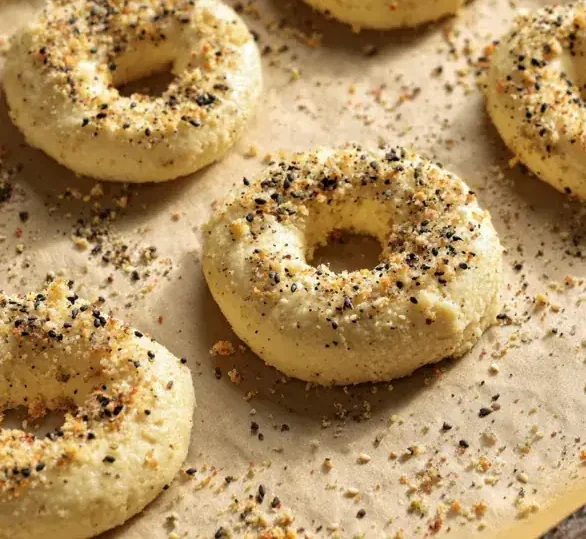 These Protein Bagels With Almond Flour Are So Good, Even the Kids Ate Them 15 unbaked almond Protein Bagels with Almond Flour with everything seasoning on parchment paper