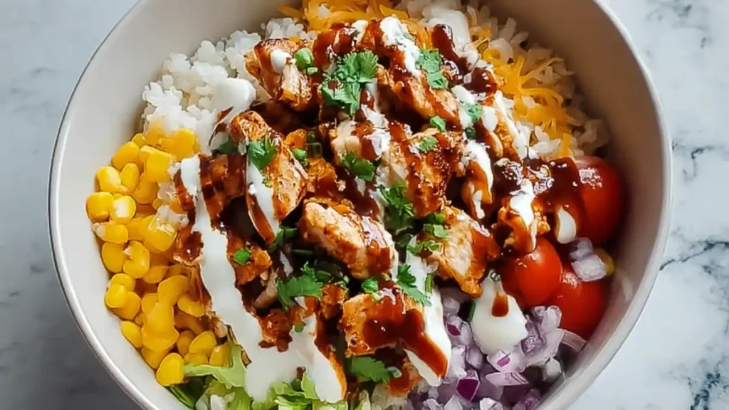 Irresistible High Protein BBQ Ranch Chicken Bowl Recipe 4 Chicken burrito bowl with rice, corn, tomatoes, onions, cheese, lettuce, and cilantro