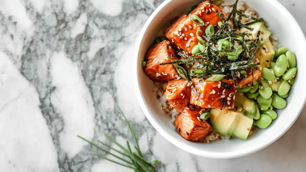 Flavorful High-Protein Salmon Bowl 4 bowl with teriyaki salmon, avocado, rice, edamame, and sesame seeds