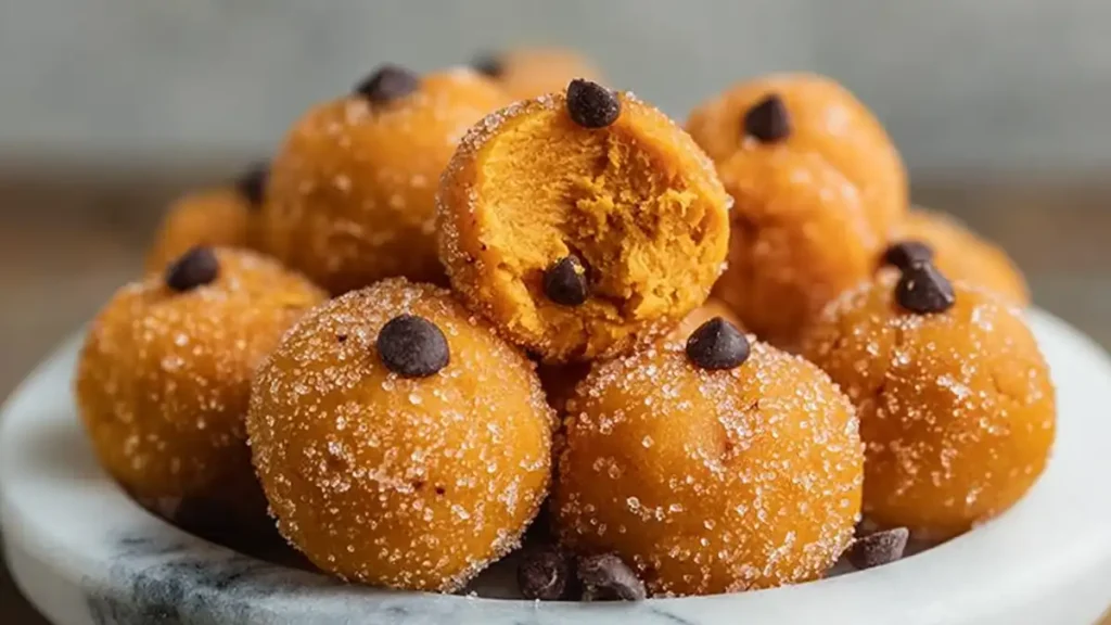 Spooktacular Halloween Treats: 14 Family-Tested Recipes You’ll Love 3 close-up of sugar-coated pumpkin cookie dough bites with chocolate chips
