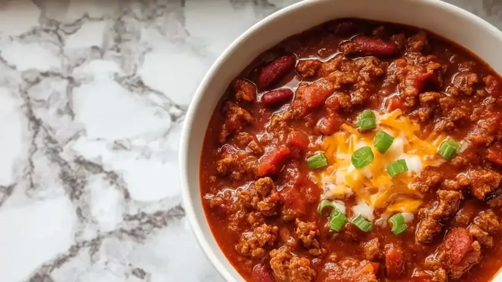 The Best Crock Pot Chili 5 Bowl of classic beef chili with red beans, ground beef, shredded cheddar, and green onions