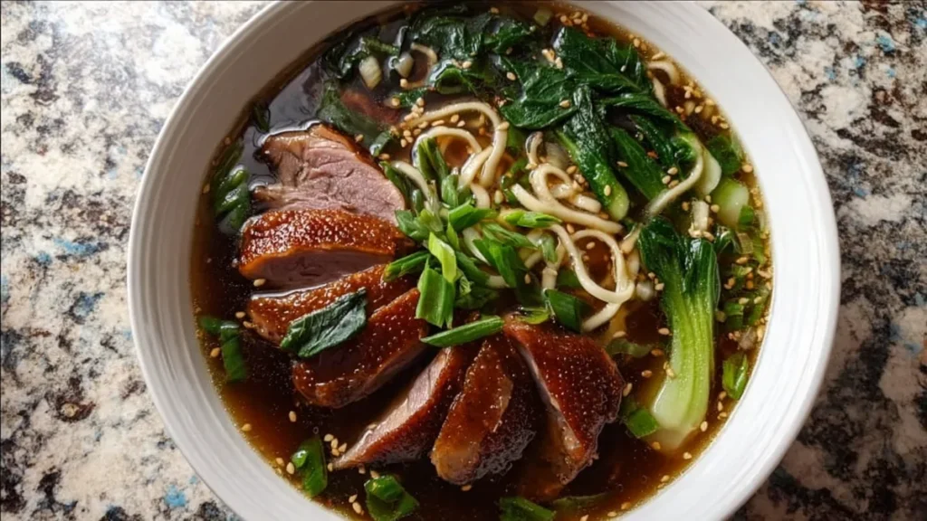 Chinese Duck Noodle Soup 5 duck ramen with noodles, bok choy, and sesame seeds in broth