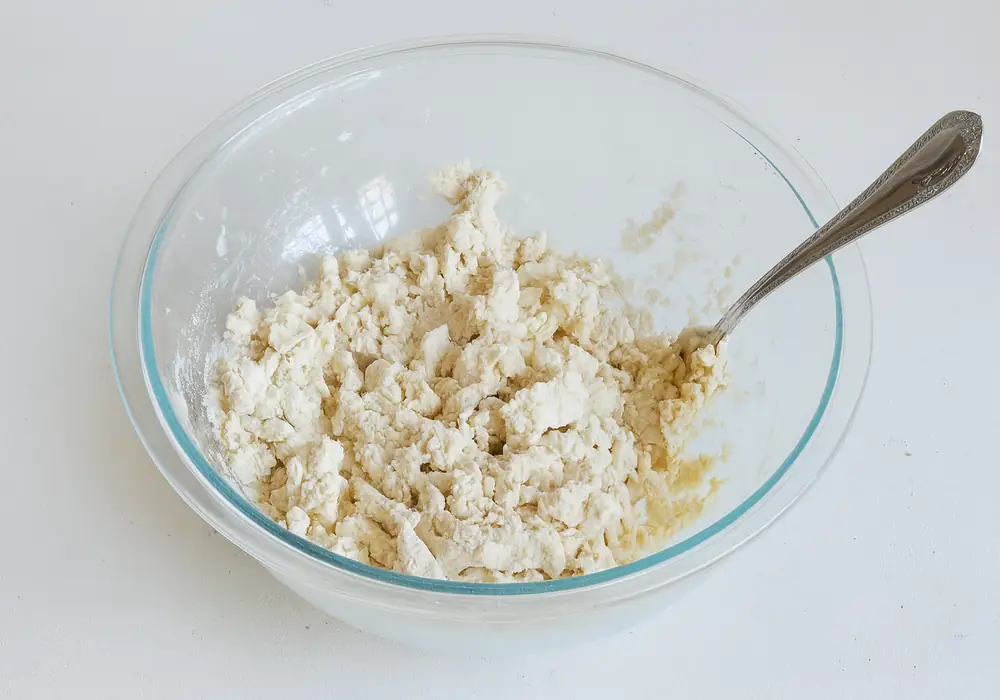 High Protein Bagel with Greek Yogurt Recipe You’ll Actually Crave 19 High Protein Bagel with Greek Yogurt: Crumbly bagel dough mixture with Yogurt added in a glass bowl with spoon