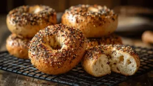 Low Carb High Protein Bagels, Freshly baked topped with sesame, poppy seeds, and spices on cooling rack
