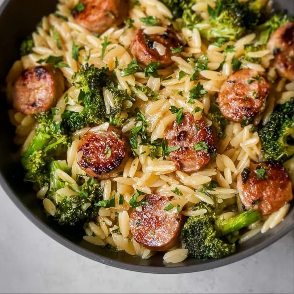 Bowl of Chicken Sausage and Broccoli Orzo with herbs and cheese