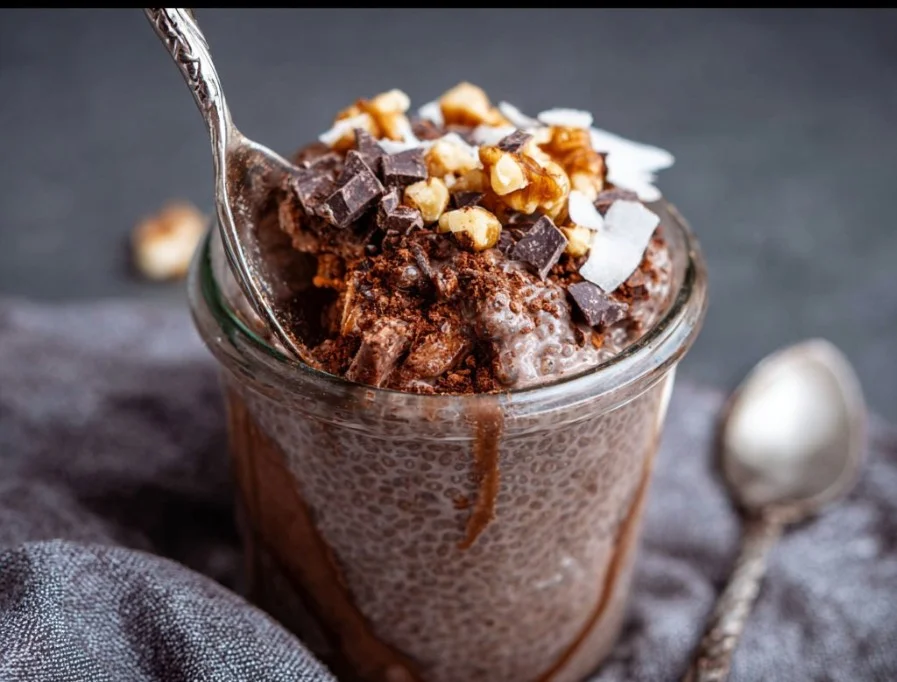 Delicious chocolate coconut chia pudding in a bowl topped with coconut flakes.