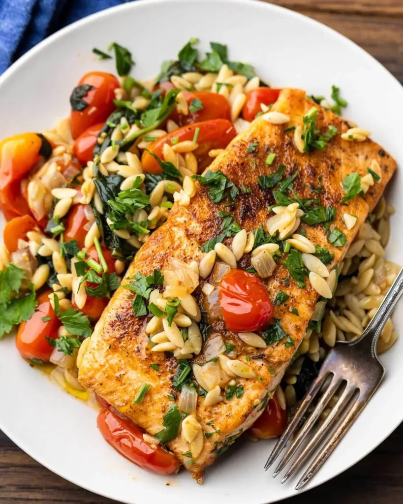 Cajun salmon with orzo and spinach served on a plate