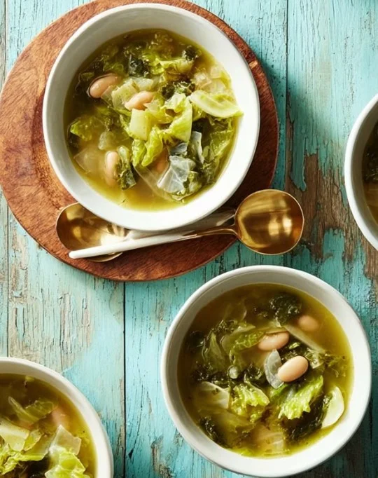 Warm bowl of homemade soup with fresh ingredients on a wooden table