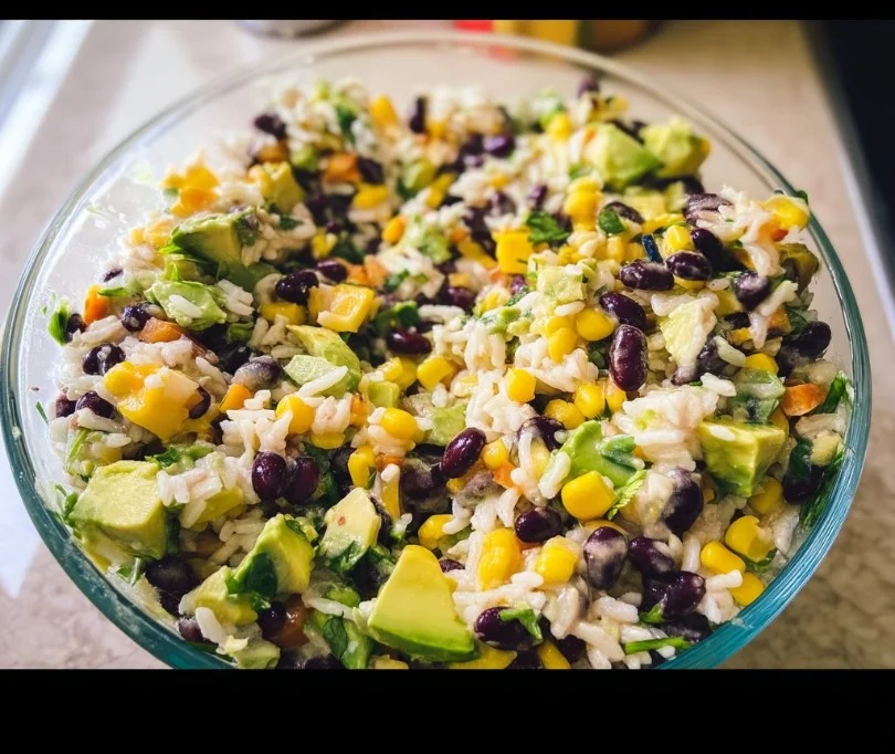 Colorful black bean salad with fresh veggies and herbs in a bowl.
