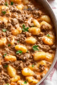 Creamy tomato gnocchi dish with ground beef served in a bowl.