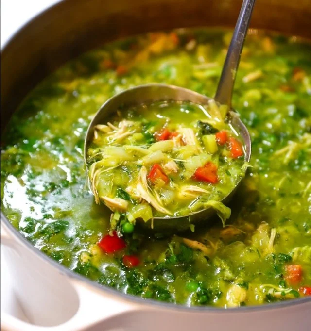 Bowl of Peruvian chicken rice soup garnished with fresh cilantro
