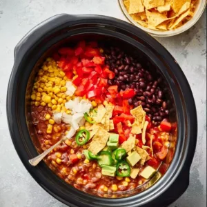 Bowl of creamy vegetarian tortilla soup topped with tortilla strips and avocado