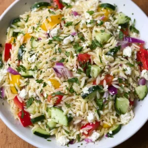 Healthy lemon orzo salad served in a bowl for summer picnics.