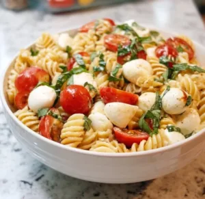 Creamy Caprese Pasta Salad with tomatoes, mozzarella, and basil