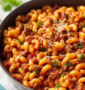Creamy One-Pot Beefaroni served in a bowl with cheese and herbs