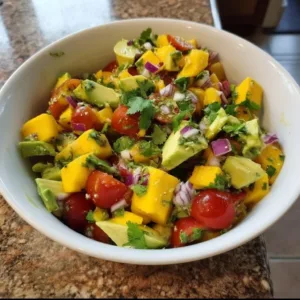 Tangy avocado mango salad with fresh ingredients and vibrant colors.
