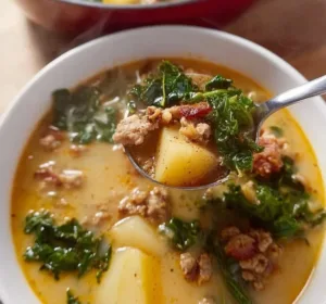 Healthy Whole30 Zuppa Toscana soup served in a bowl with greens.