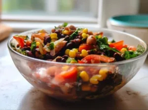 Colorful bowl of savory Mexican Bean Salad with fresh vegetables and beans.